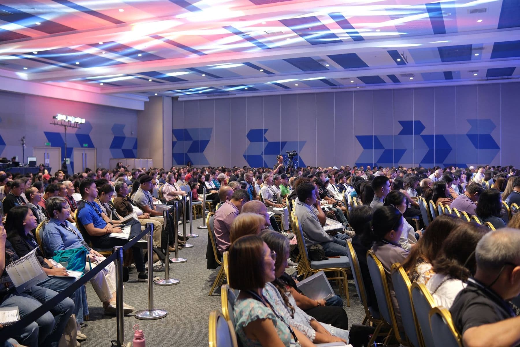 A wide view of delegates seated between sessions