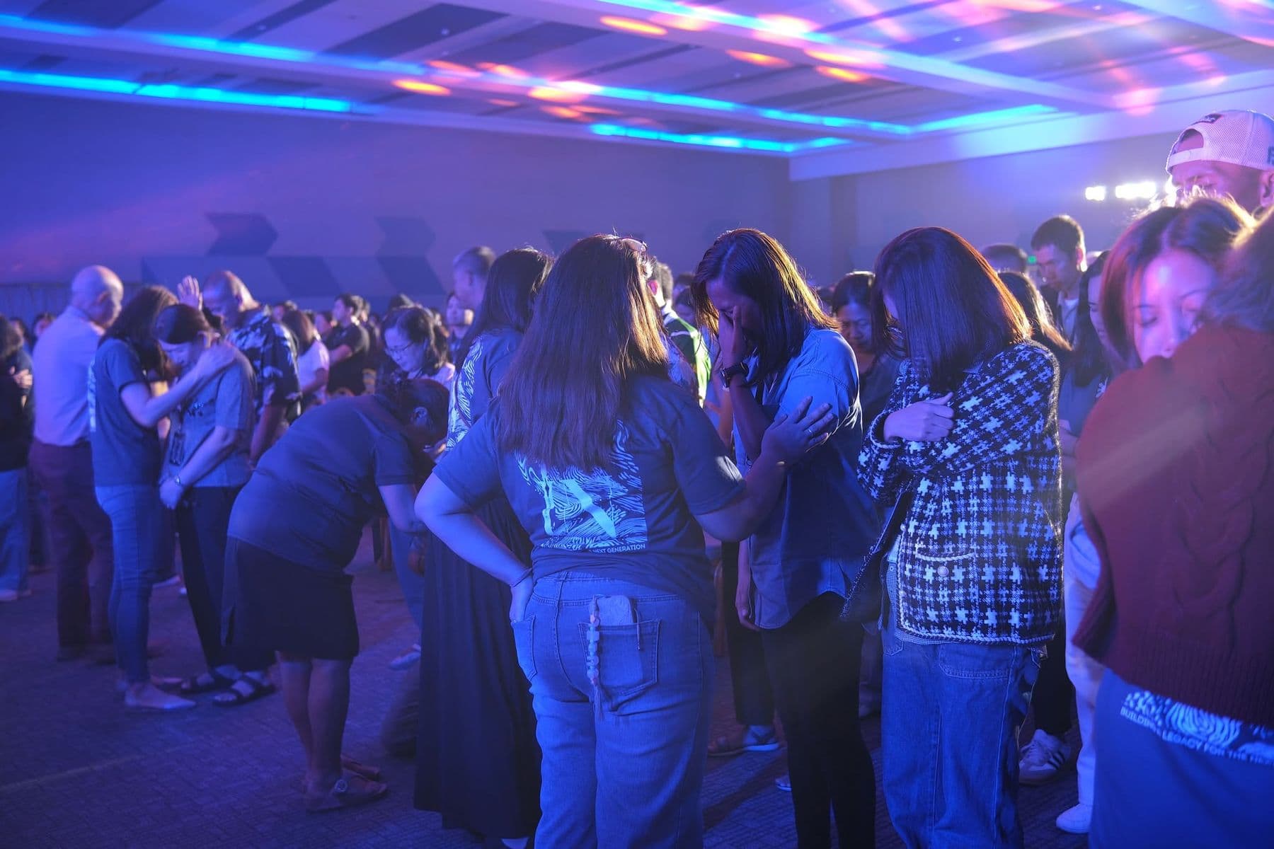 Delegates gathered in small groups, praying for one another
